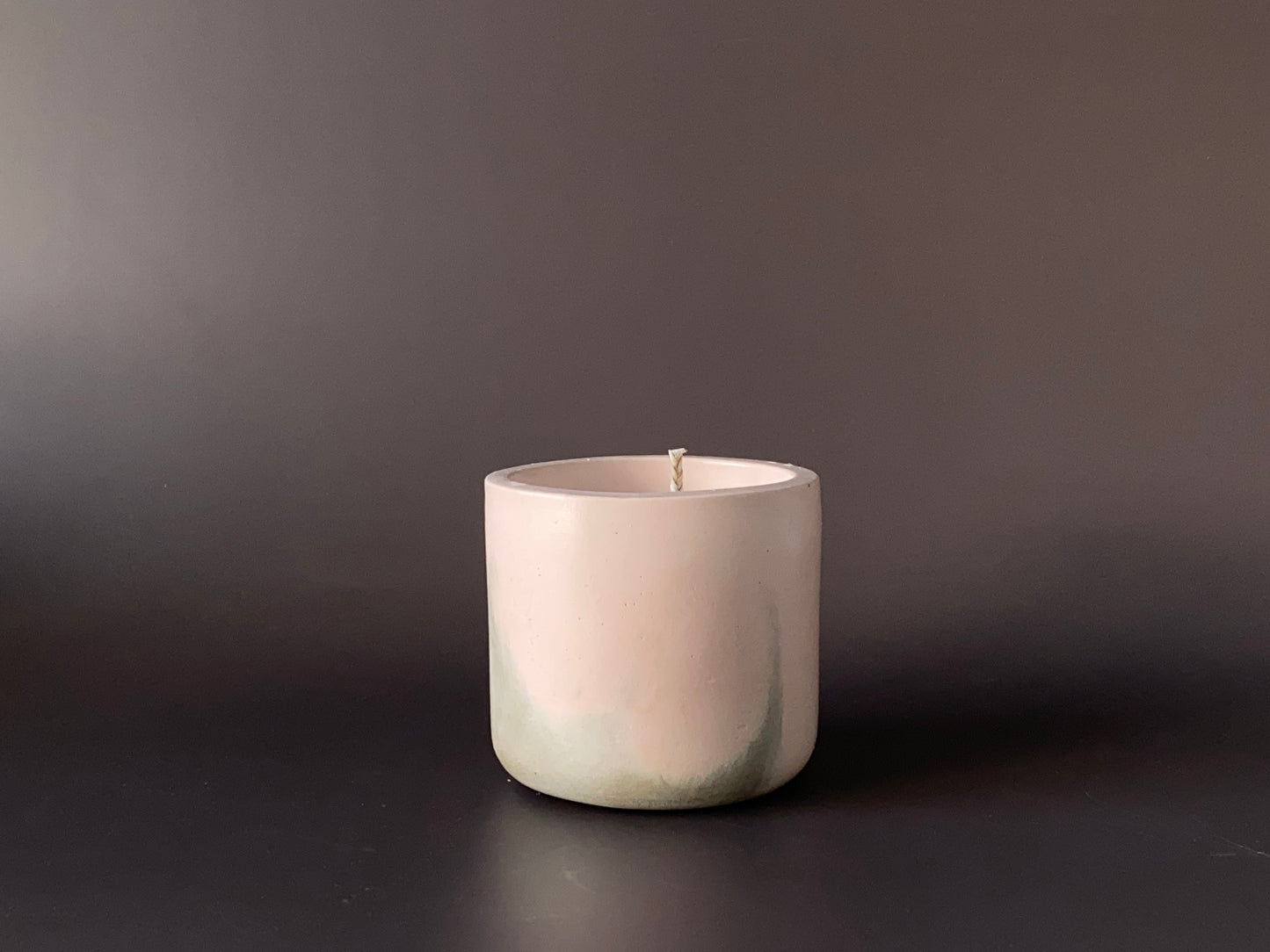 Hand-poured soy-wax candle in a handmade concrete jar for minimalist home decor