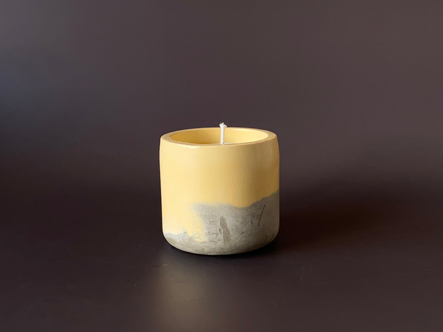 Hand-poured soy-wax candle in a handmade concrete jar for minimalist home decor