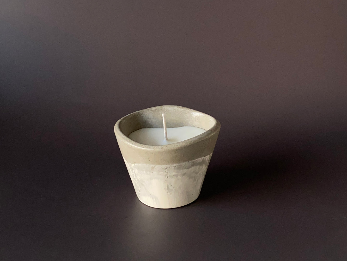 Hand-poured soy-wax candle in a handmade concrete jar for minimalist home decor