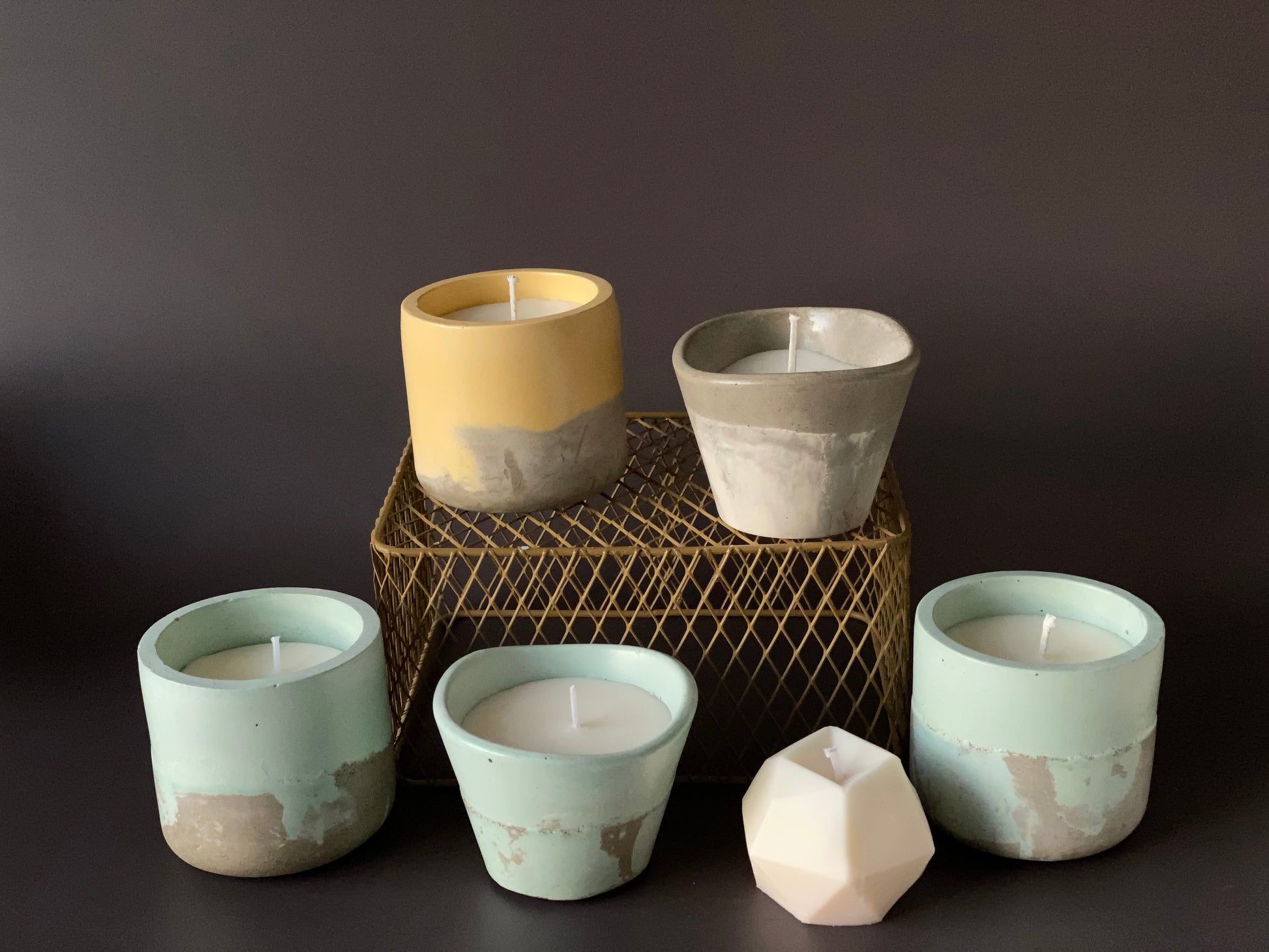 Various Hand-poured soy-wax candles in handmade concrete jar for minimalist home decor