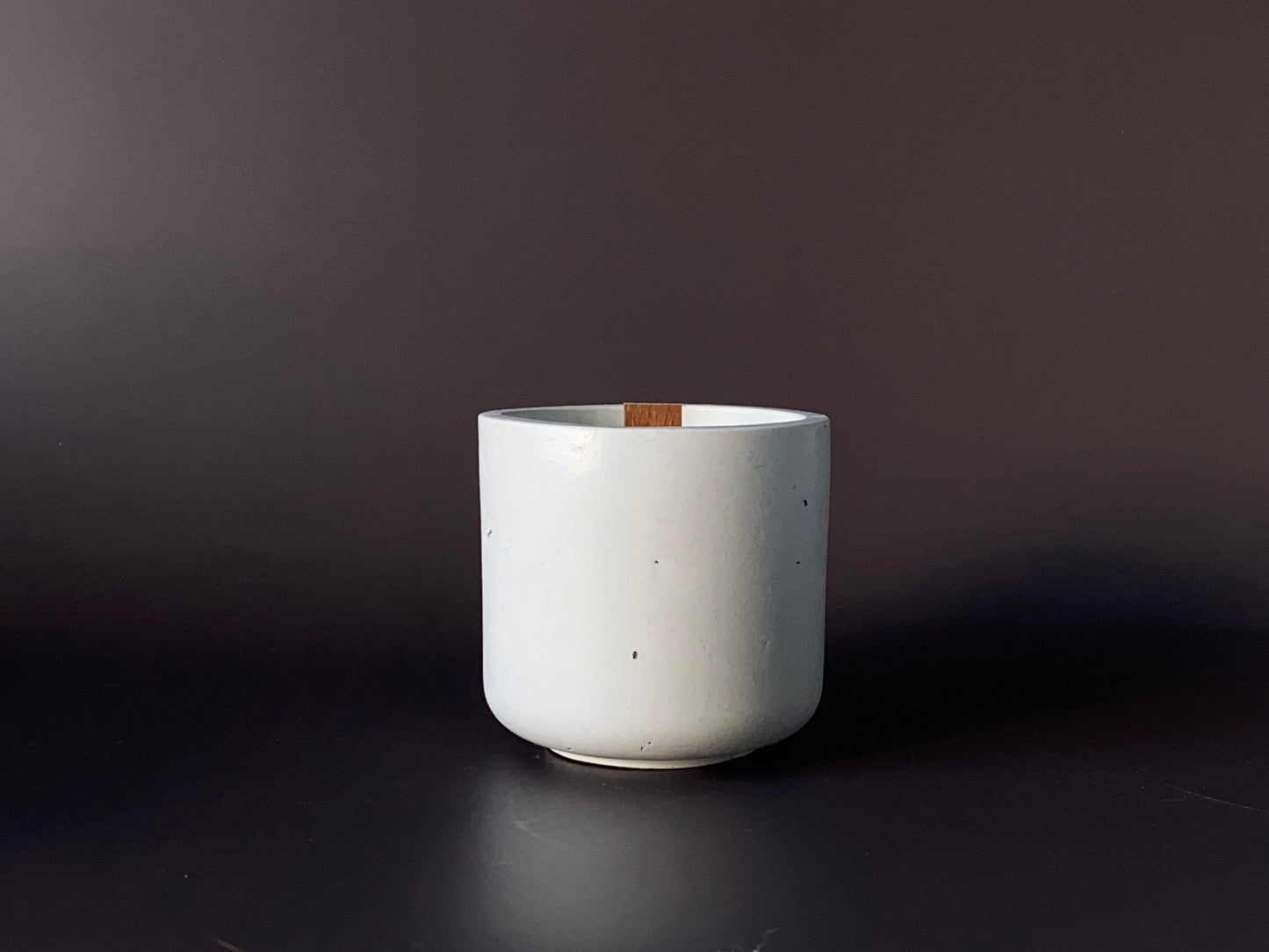Hand-poured soy-wax candle in a handmade concrete jar for minimalist home decor