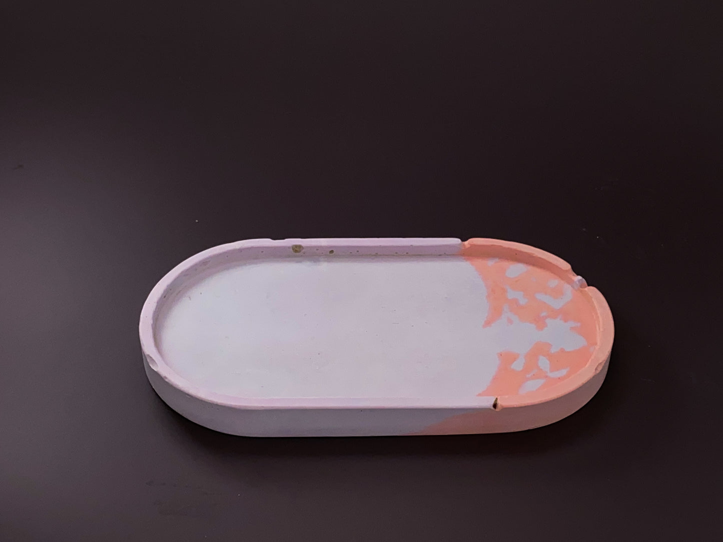 handmade concrete jewellery tray with bold design and purple and peach colour for modern interiors