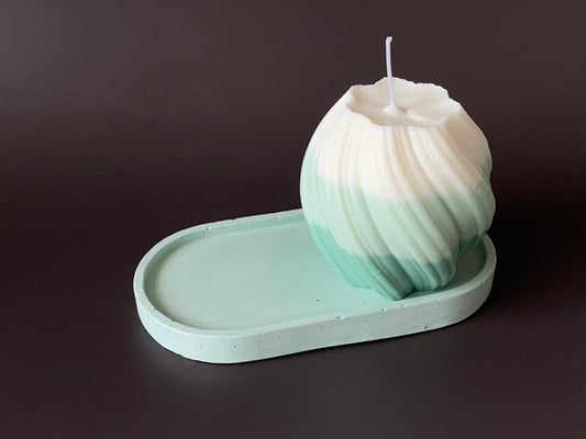 handmade concrete jewellery oval tray in green color with a hand-poured soy-wax swirl pillar candle in green and white color