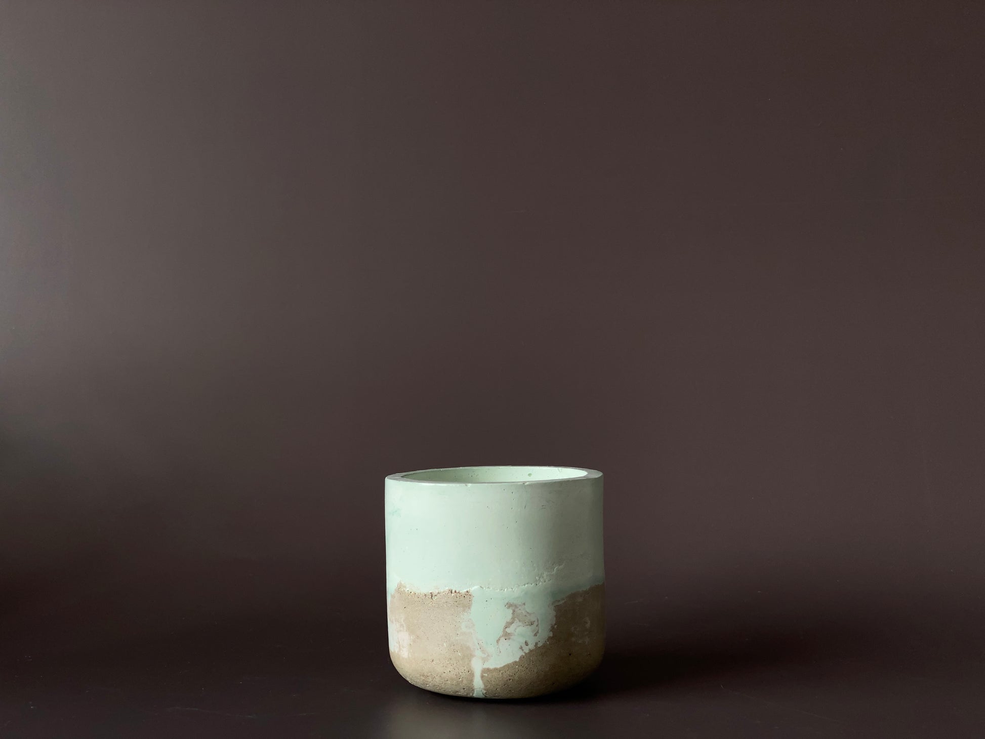 hand-poured soy-wax candle in a handmade concrete jar green and grey colour for industrial and minimalist home decor