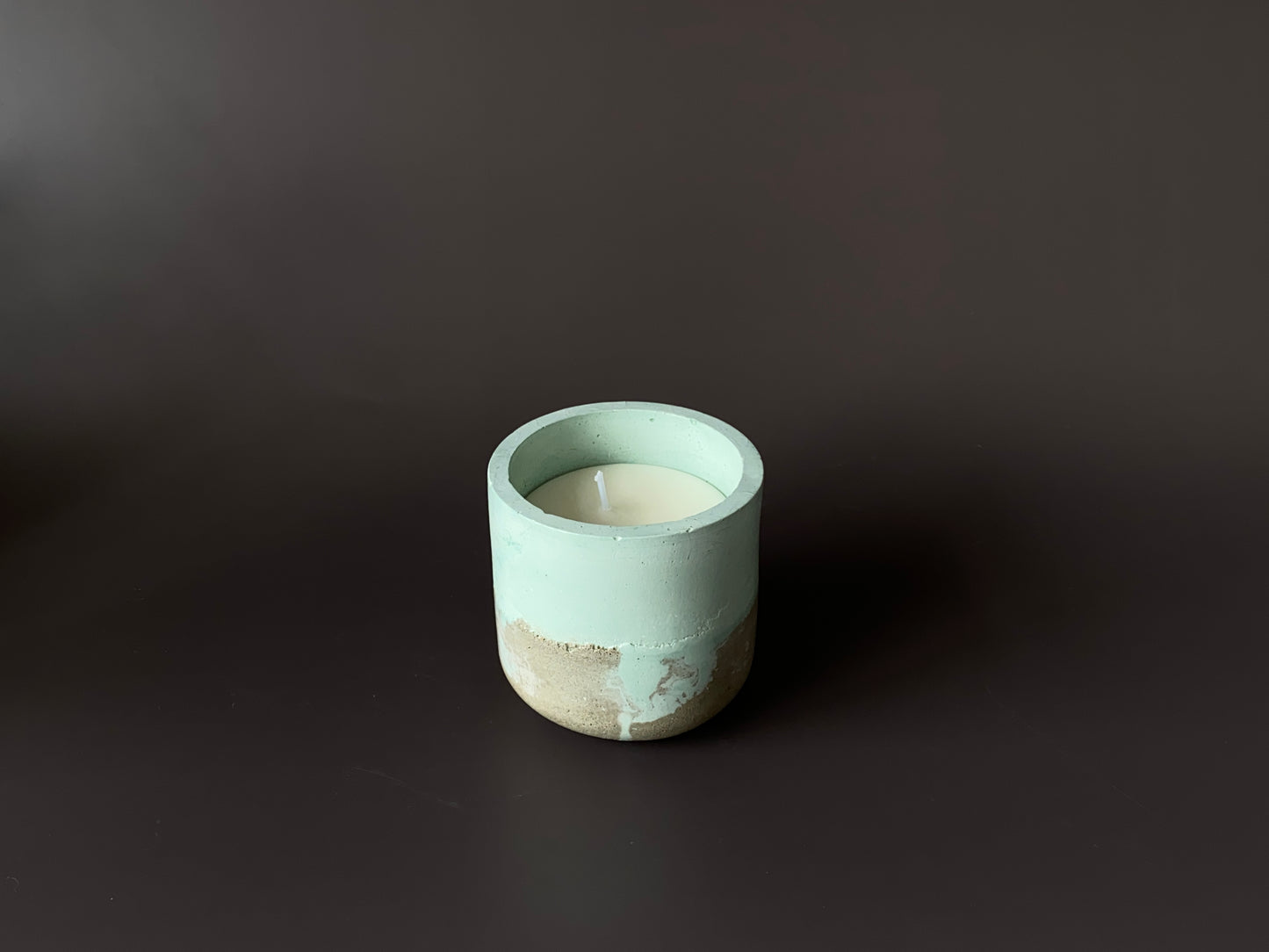 hand-poured soy-wax candle in a handmade concrete jar green and grey colour for industrial and minimalist home decor