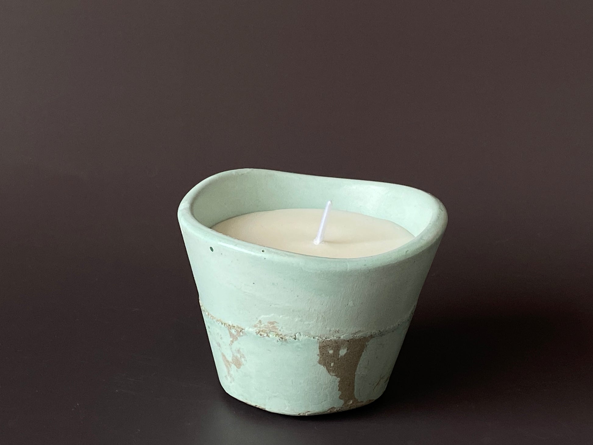 Hand-poured soy-wax candle in a handmade concrete jar for minimalist home decor